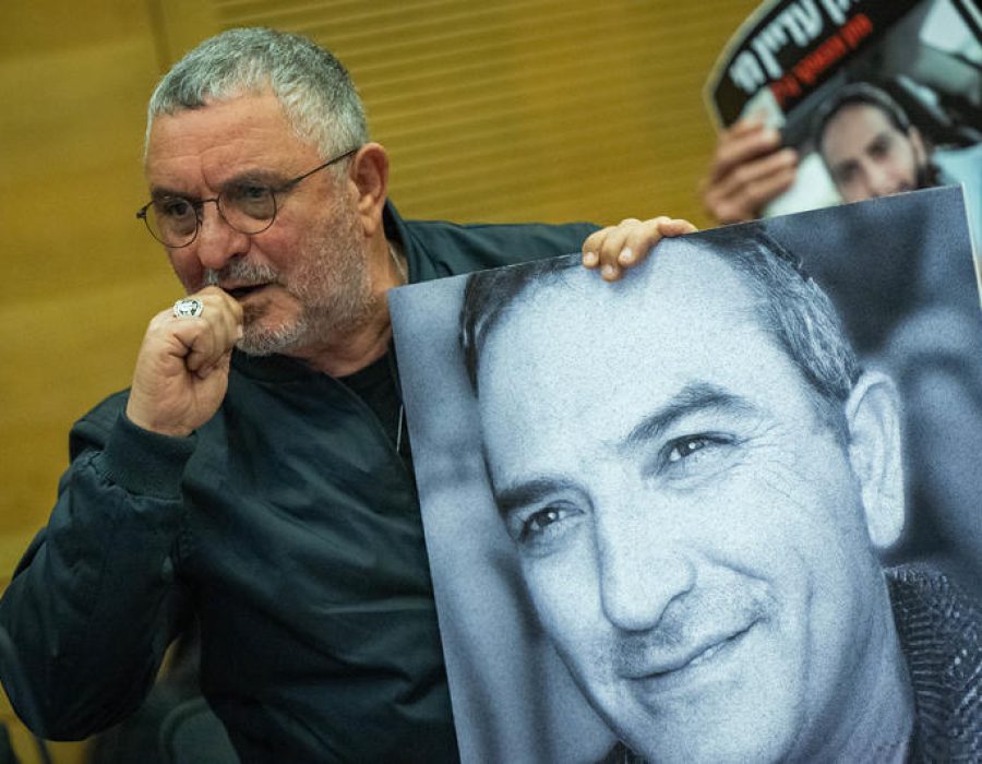 Danny Elgarat met een foto van zijn door Hamas vermoorde broer Itzhik - Foto: Yonatan Sindel/Flash90